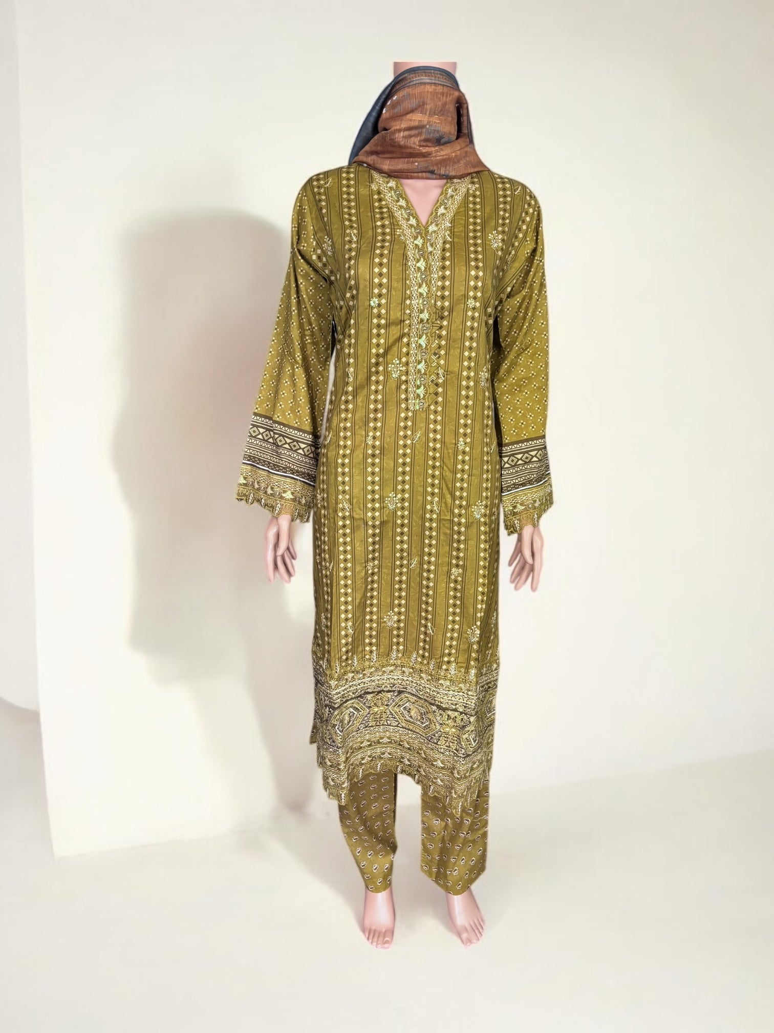 Traditional Pakistani Salwar Kameez by Saree Ghor Charlotte, showcasing vibrant ethnic wear for women with intricate patterns and colorful fabric.