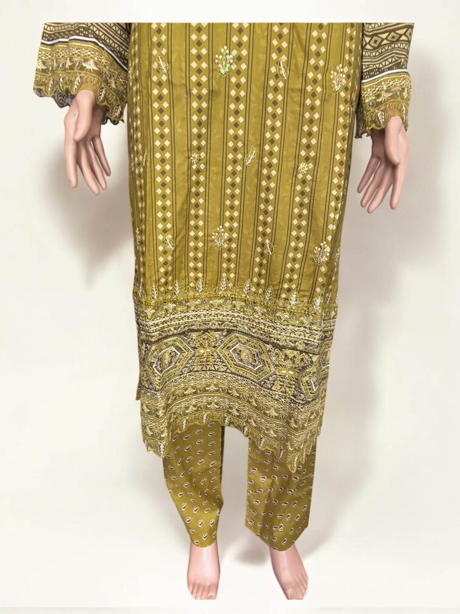 Traditional Pakistani Salwar Kameez by Saree Ghor Charlotte, elegant ethnic wear for women featuring intricate embroidery and vibrant fabric.