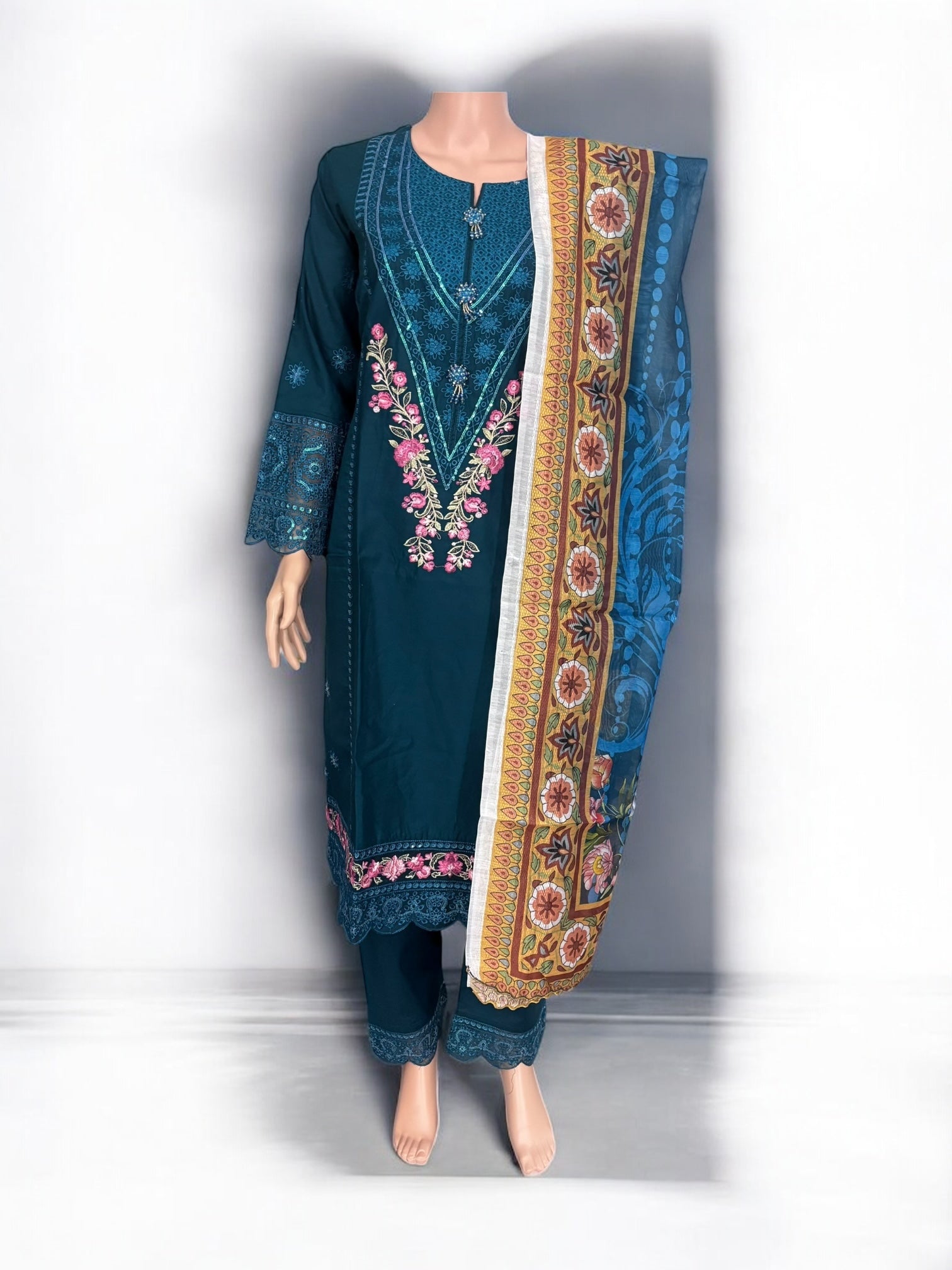 Traditional Salwar Kameez set by Saree Ghor Charlotte featuring intricate embroidery and vibrant fabric for women's ethnic wear.