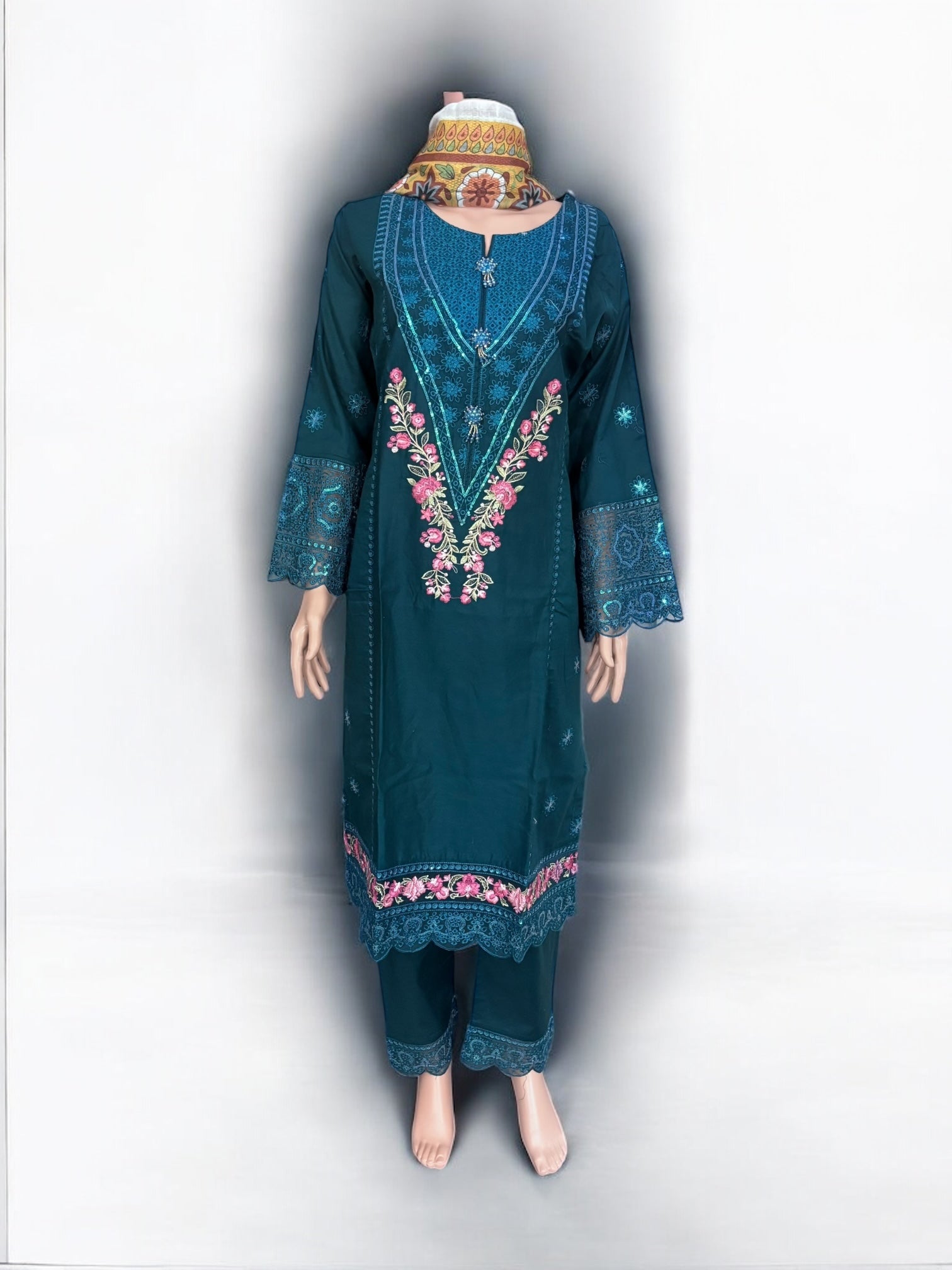 Traditional Salwar Kameez set by Saree Ghor Charlotte featuring intricate embroidery and vibrant fabric for women's ethnic wear.