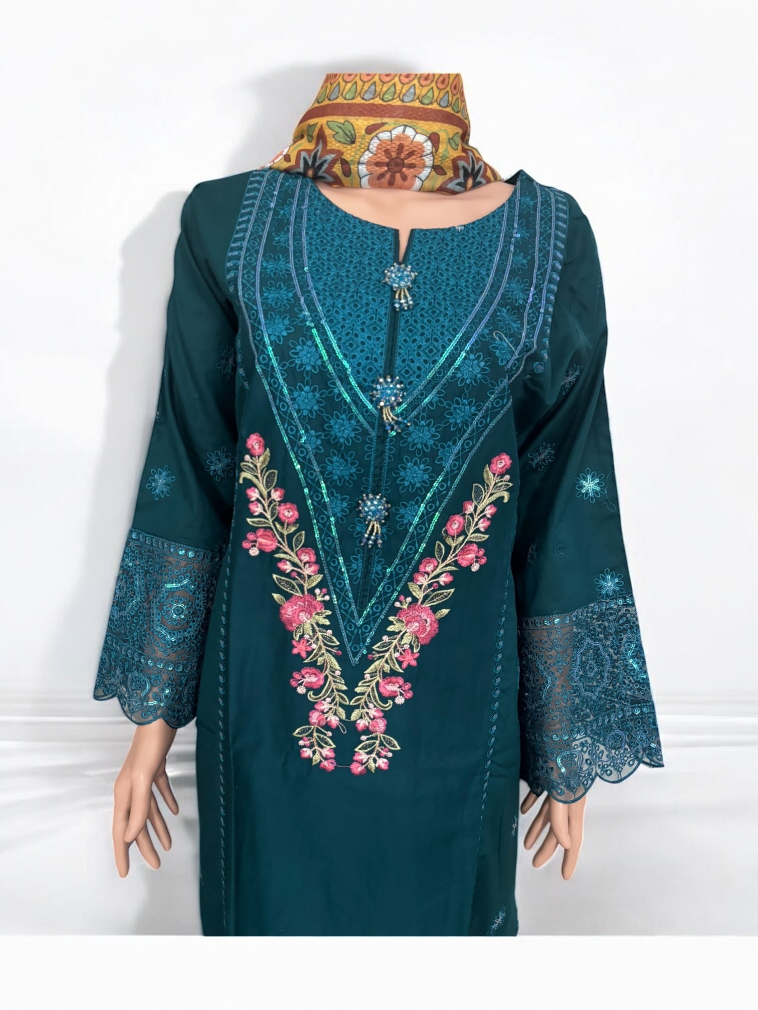 Traditional Salwar Kameez set by Saree Ghor Charlotte, women’s ethnic wear with intricate embroidery and vibrant colors.
