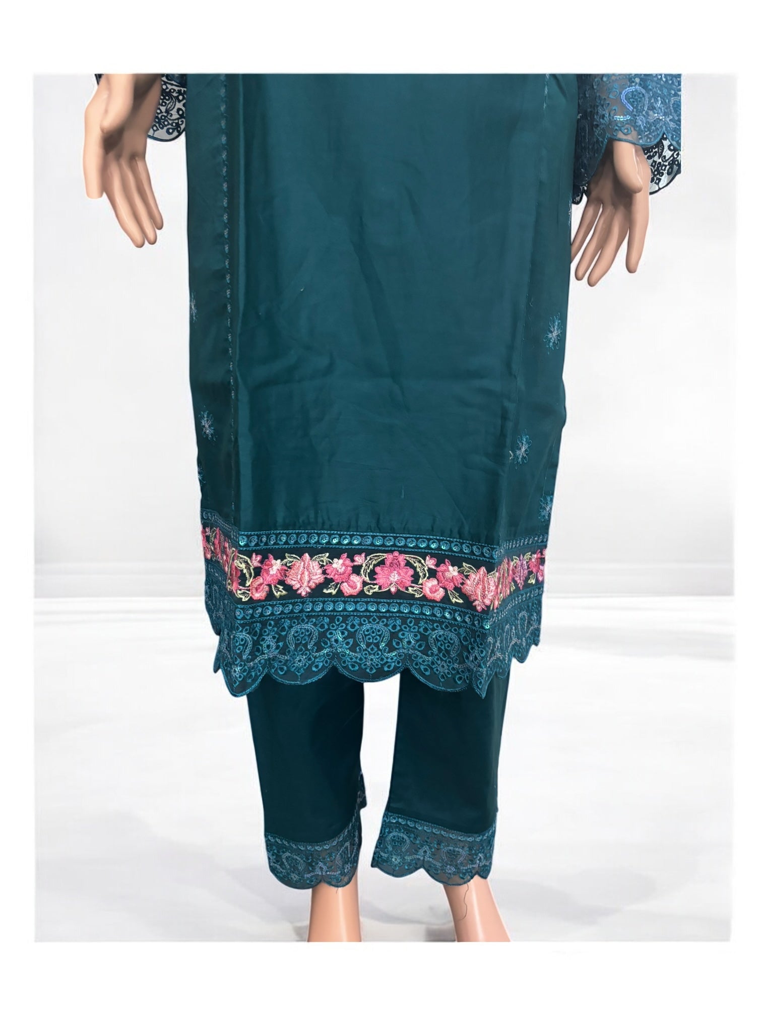 Traditional Salwar Kameez set from Saree Ghor Charlotte featuring intricate embroidery and vibrant fabric for women.