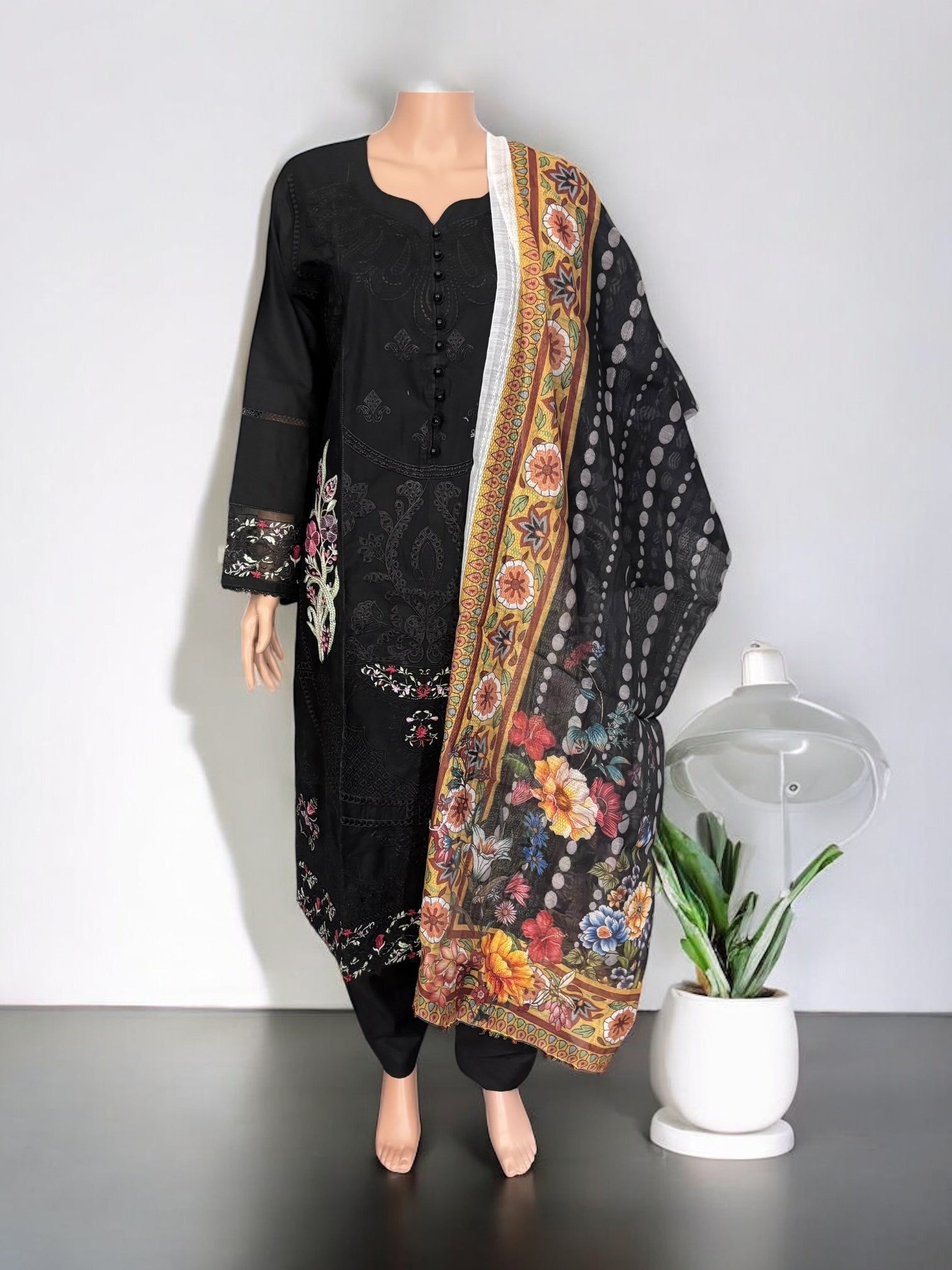 Traditional Salwar Kameez Set by Saree Ghor Charlotte featuring embroidered fabric, vibrant colors, and elegant ethnic style for women.