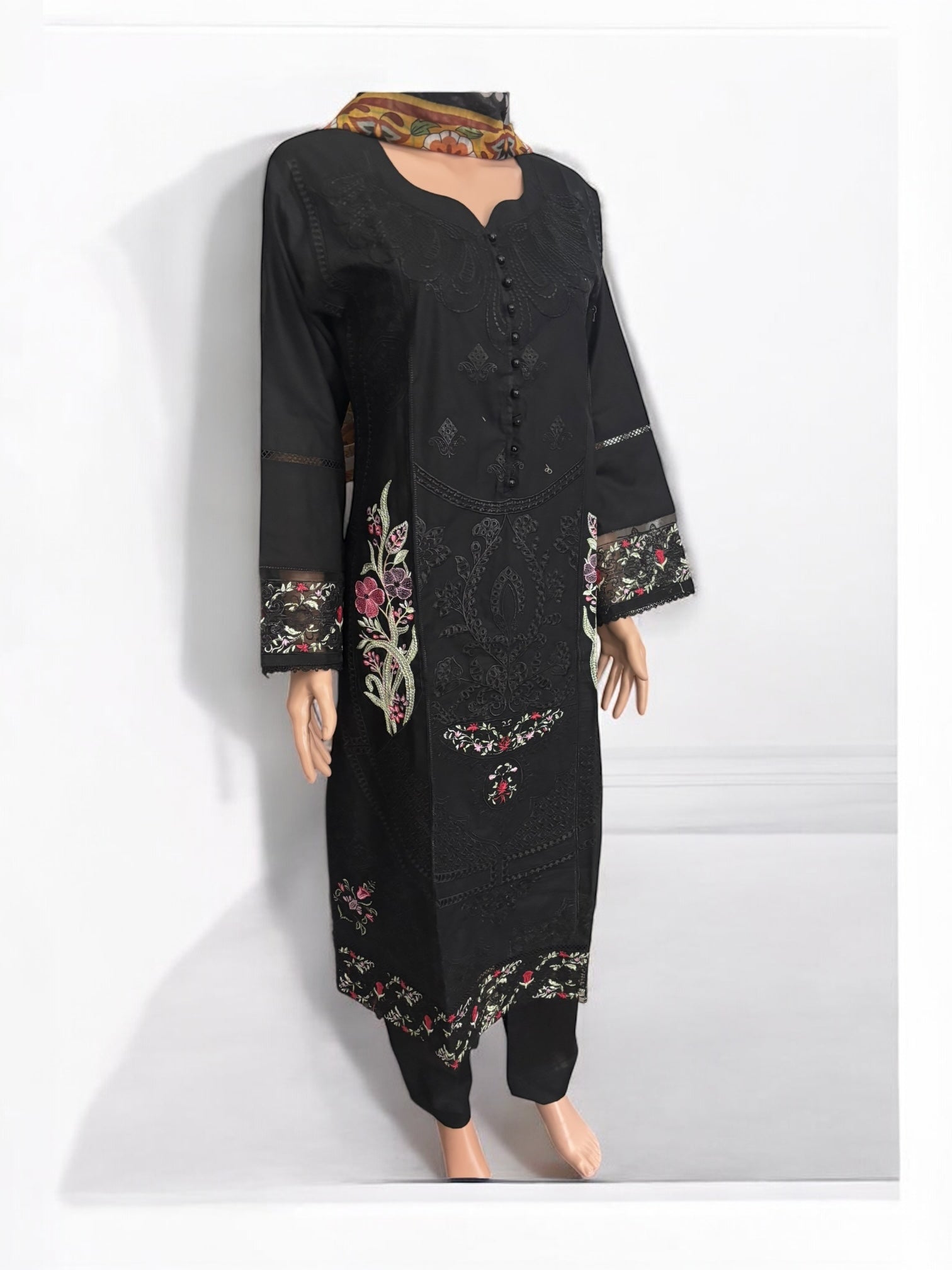 Traditional Salwar Kameez set for women by Saree Ghor Charlotte, featuring vibrant ethnic wear with intricate patterns and bright colors.