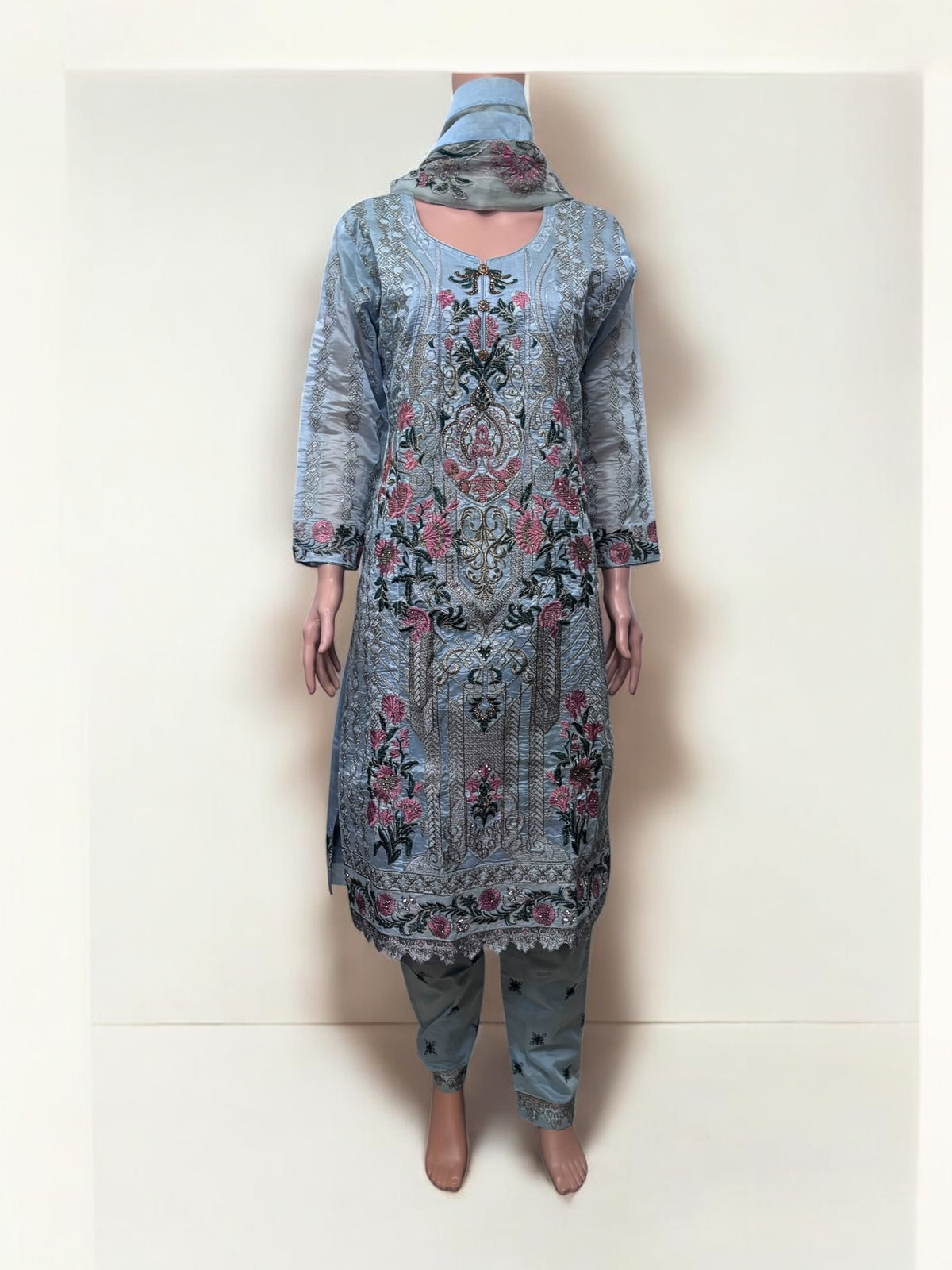 Traditional Salwar Kameez set by Saree Ghor Charlotte featuring ethnic wear for women with colorful fabric and intricate embroidery.
