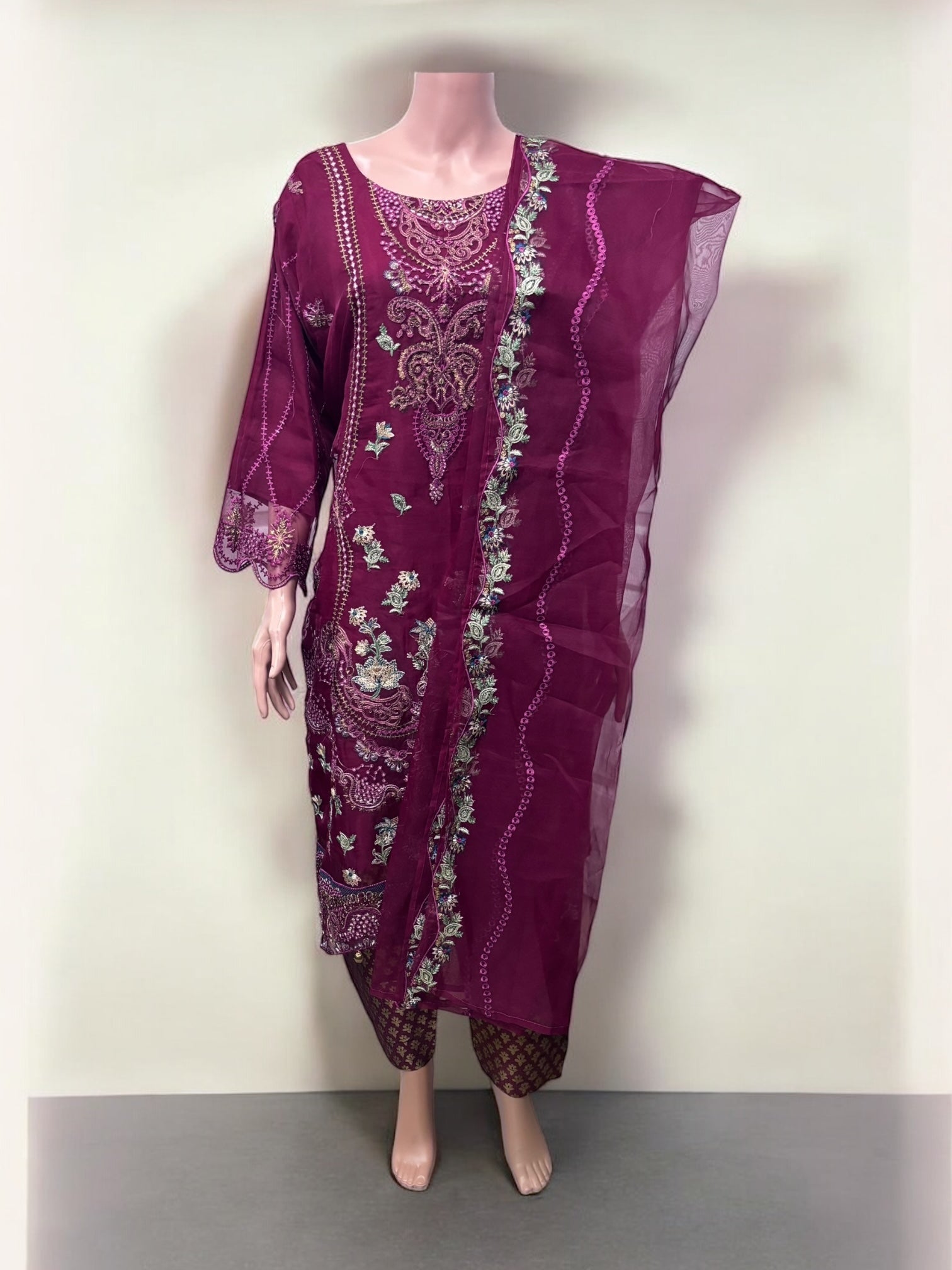 Traditional Salwar Kameez set by Saree Ghor Charlotte featuring colorful ethnic wear for women, with intricate embroidery and vibrant fabric.