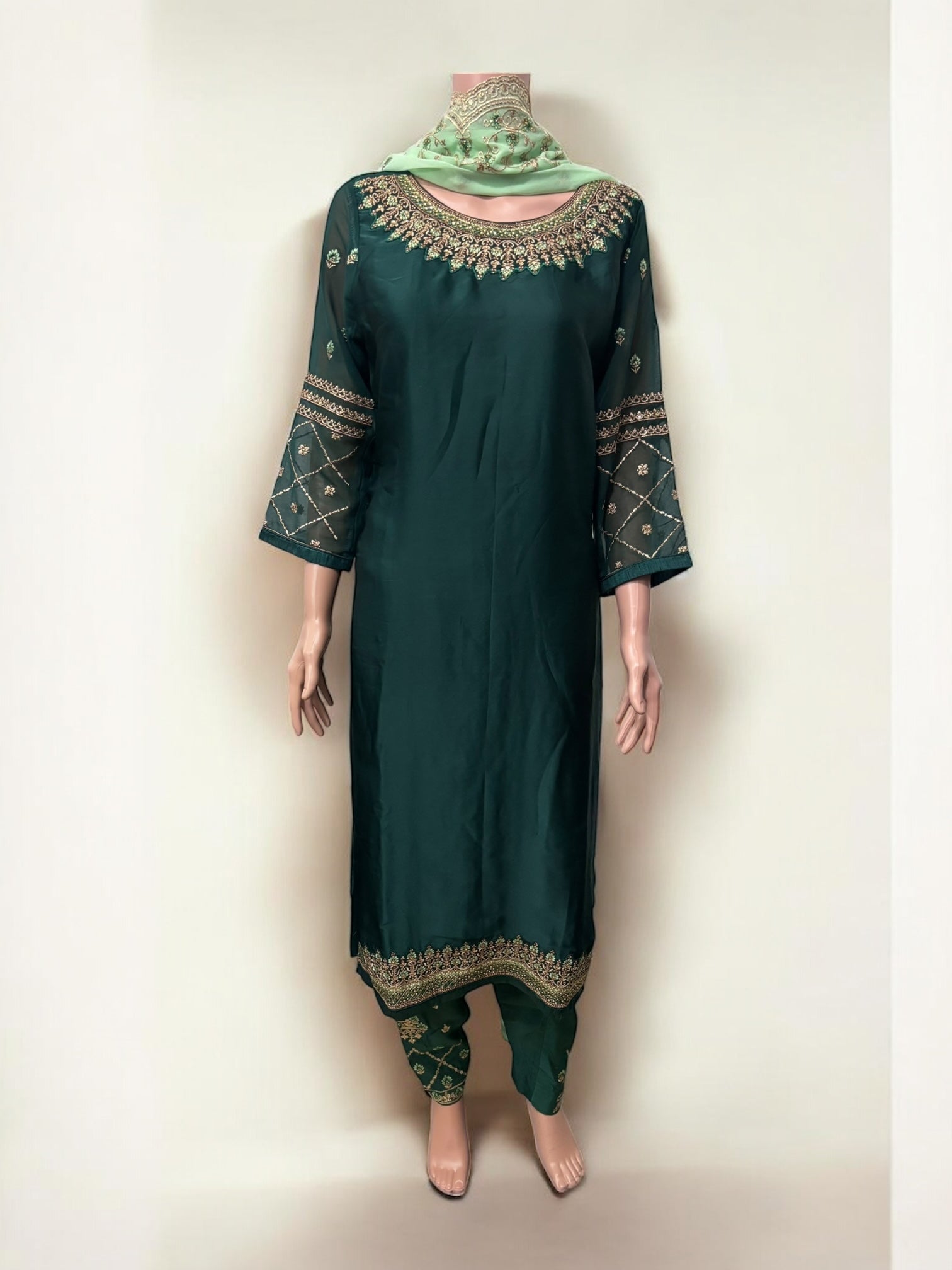Traditional Salwar Kameez set by Saree Ghor Charlotte, ethnic women’s wear with intricate fabric and vibrant design details.