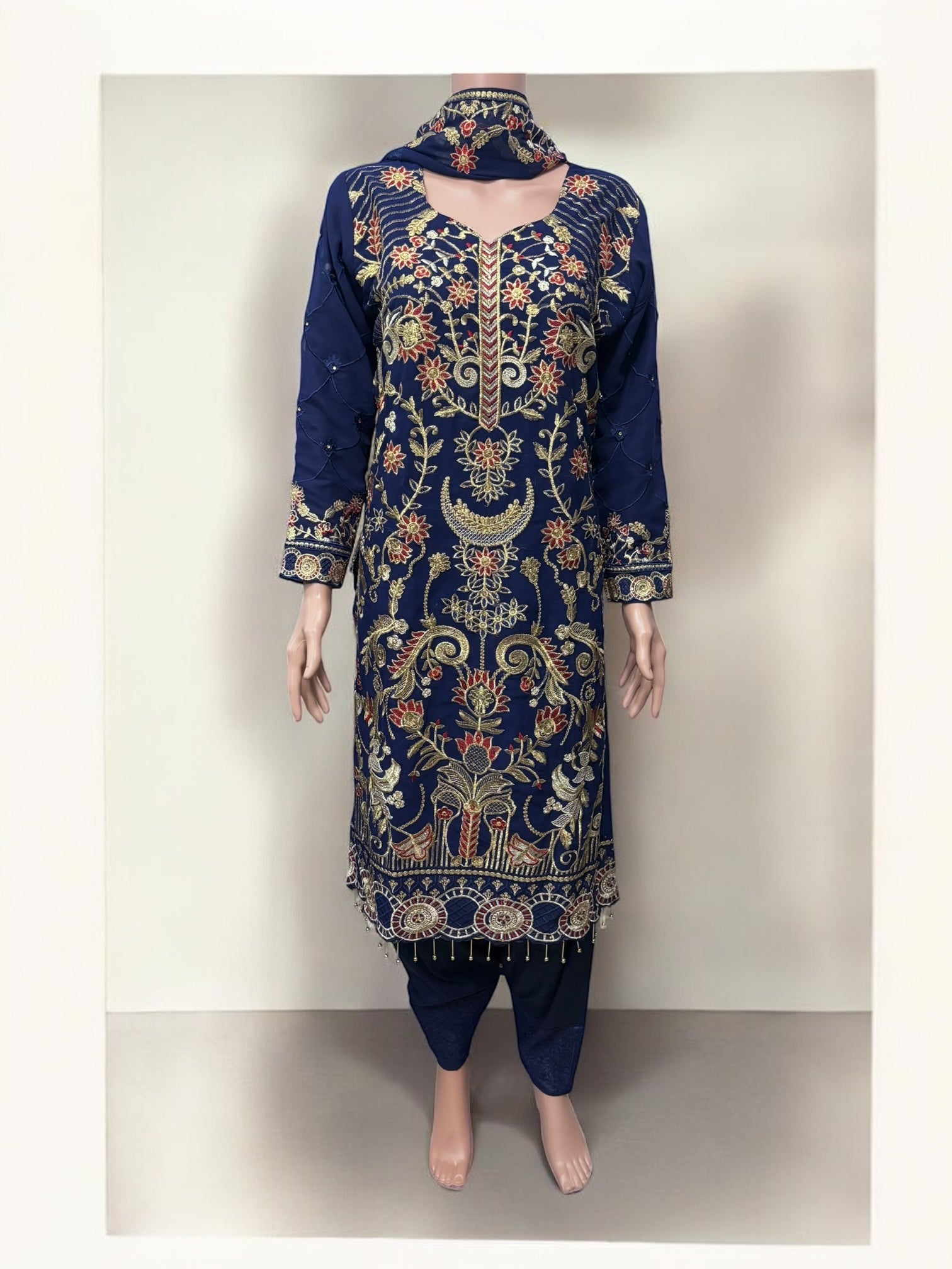 Traditional Salwar Kameez set by Saree Ghor Charlotte, elegant ethnic wear for women with detailed fabric and vibrant design.