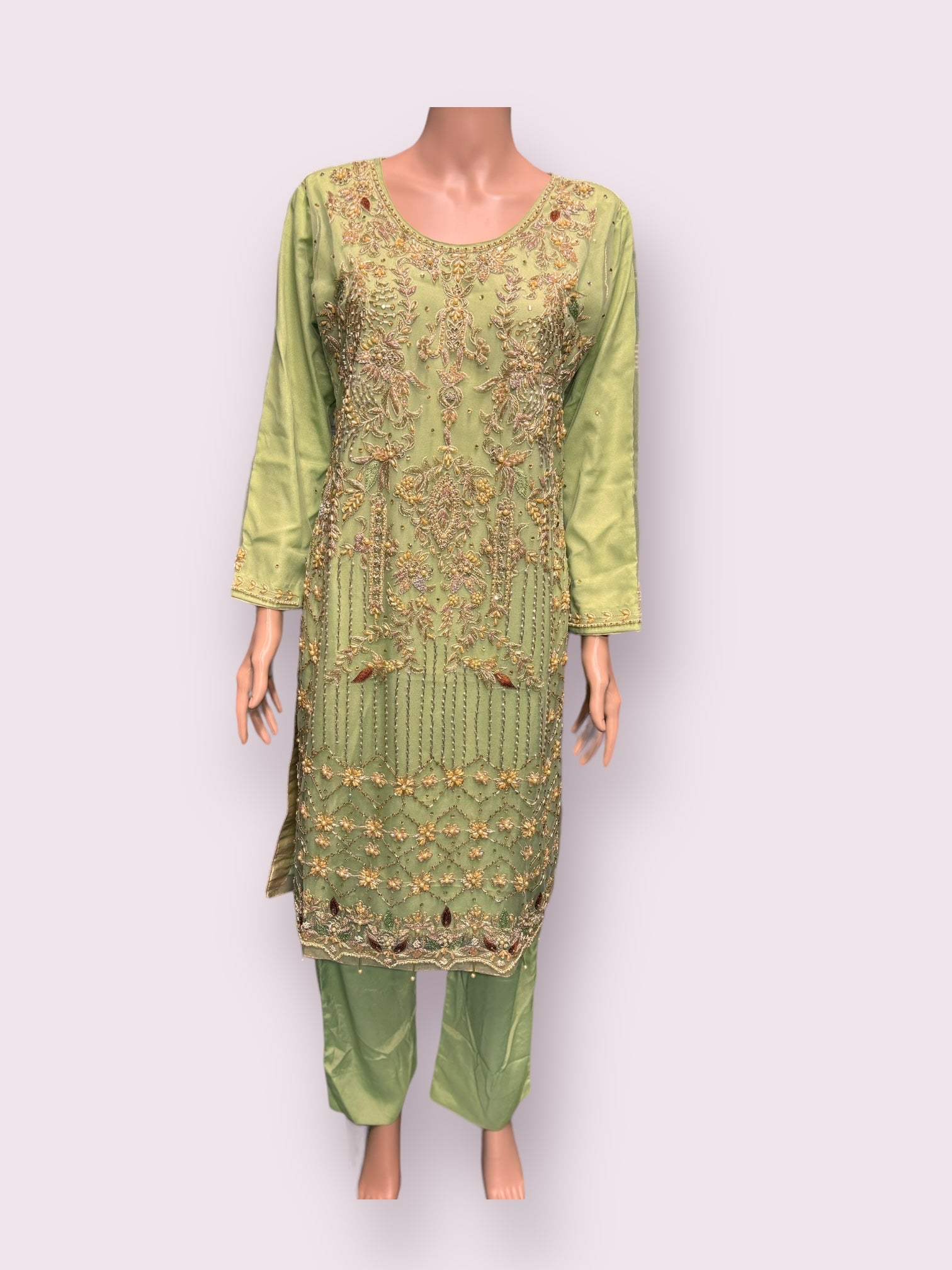 Elegant Saree Ghor Charlotte designer salwar kameez with intricate handwork, showcasing traditional craftsmanship and vibrant fabric.