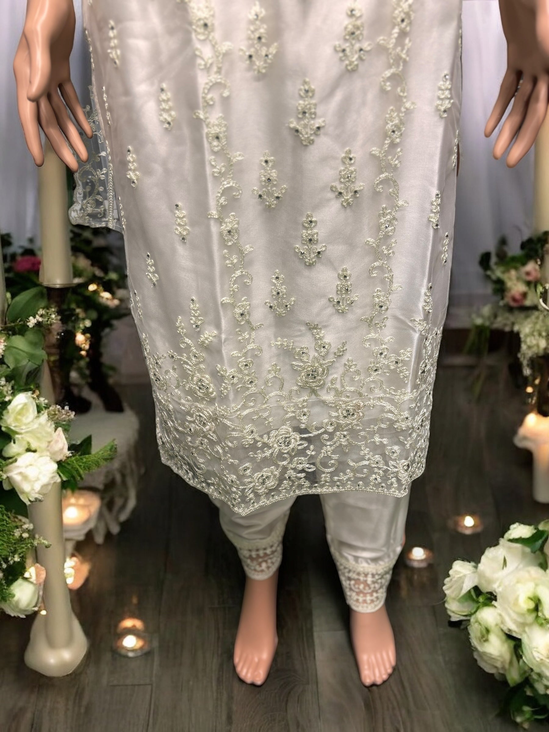 Traditional off-white designer salwar suit by Saree Ghor Charlotte, featuring intricate ethnic embroidery and elegant kameez with matching dupatta.