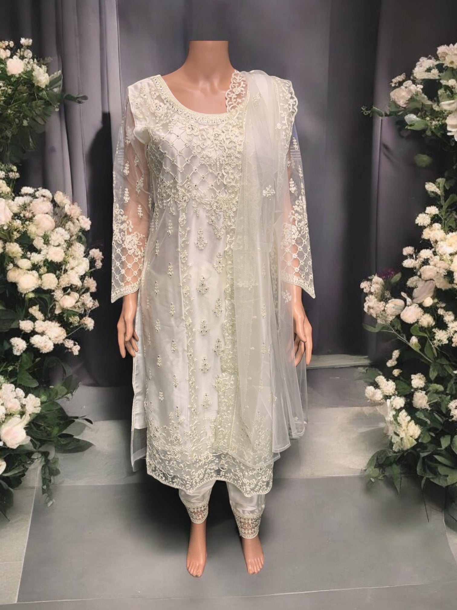 Traditional off-white designer salwar suit by Saree Ghor Charlotte, featuring intricate embroidery and ethnic wear for women.