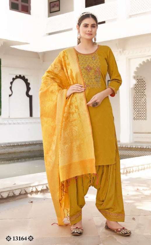 Traditional silk Salwar Kameez by Saree Ghor Charlotte, vibrant ethnic wear for women featuring intricate embroidery and elegant design.